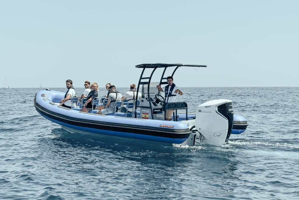 The Astec PB800 rigid inflatable boat floating on the water, showcasing its durable design, maneuverability, and high performance for navigation.