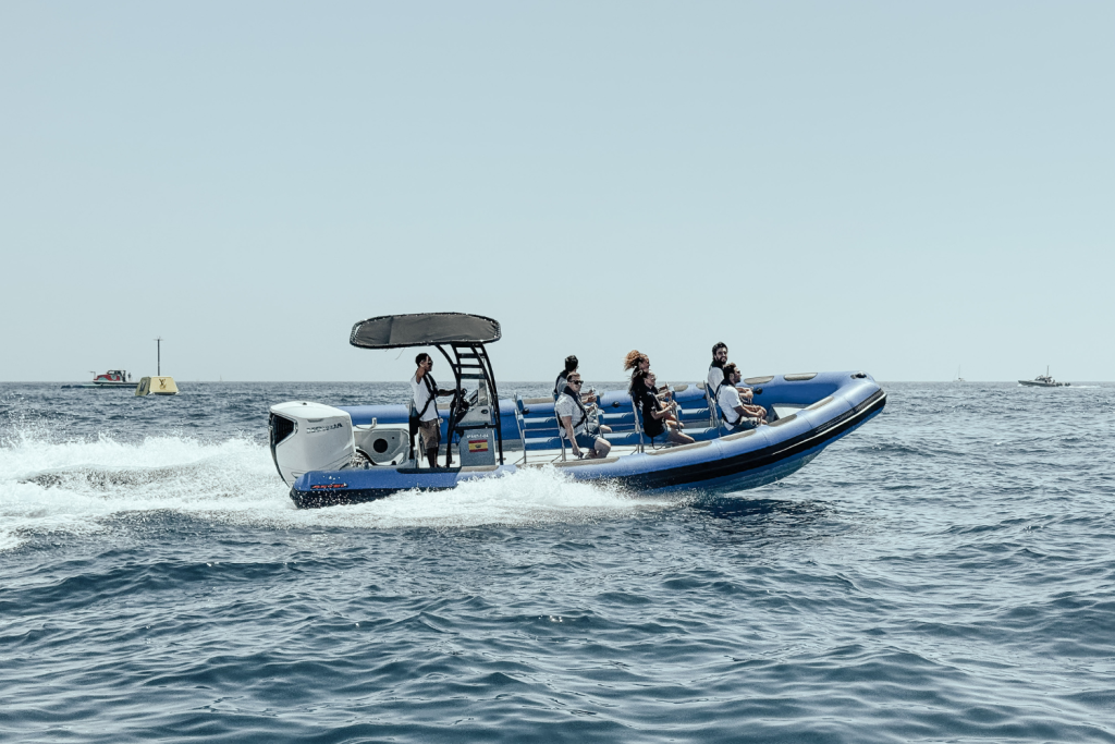 The Astec PB800 rigid inflatable boat floating on the water, showcasing its sturdy design, maneuverability, and high performance for navigation.