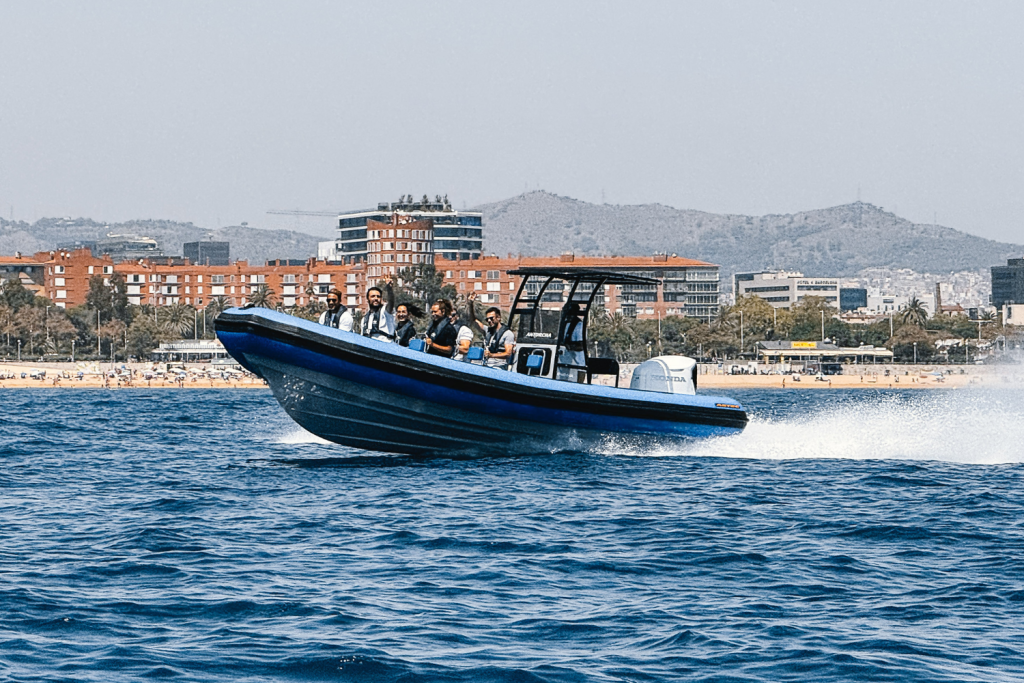 The Astec PB800 rigid inflatable boat floating on the water, showcasing its sturdy design, safety, and high performance for navigation.