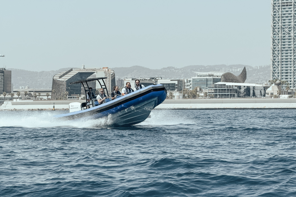 The Astec PB800 rigid inflatable boat floating on the water, showcasing its sturdy design, safety, and high performance for navigation.