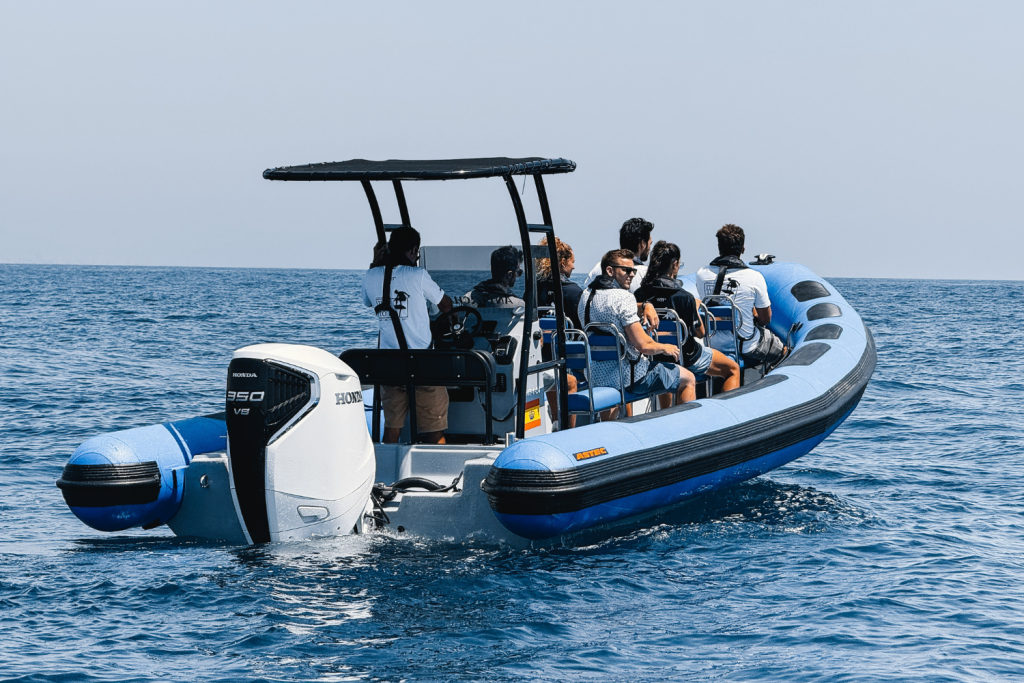 The Astec PB800 rigid inflatable boat floating on the water, showcasing its sturdy design, stability, and high performance for navigation.